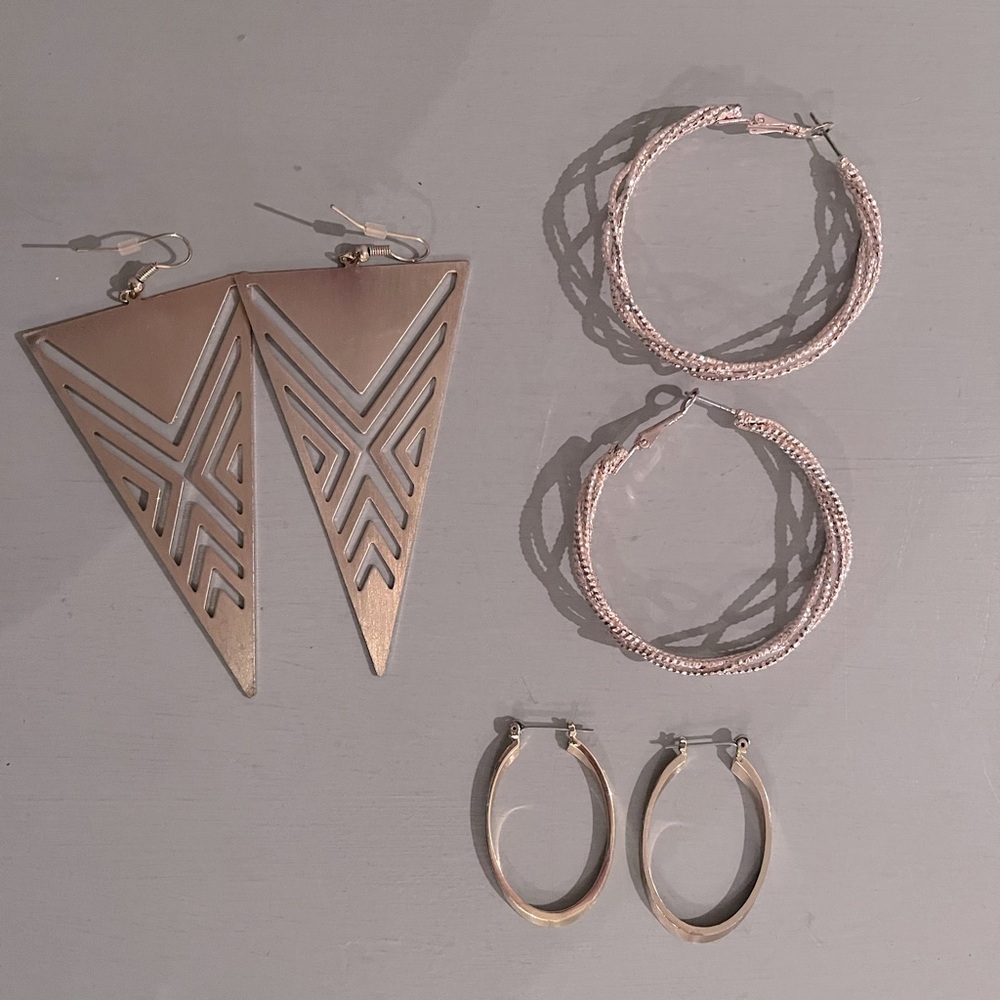 Bundle of three gold tone earrings. Two hoops and one statement earring